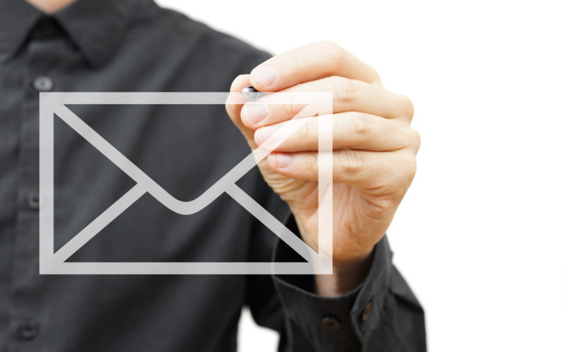 Man drawing email icon on virtual screen.  Contact information concept